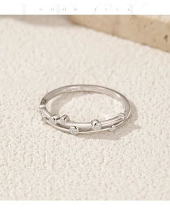 Macro shot of S925 sterling silver ring with double wave lines and inlaid round diamonds