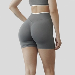 Macro rear view of seamless high-waist grey yoga shorts with white trim and scrunch butt detail