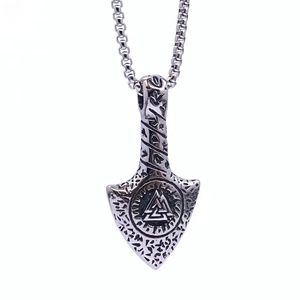 Macro shot of silver titanium steel Viking pendant with Valknut and rune engravings