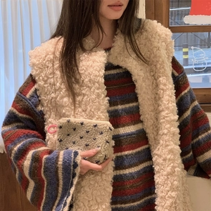 Close-up of cozy plush coin purse with blue heart pattern on soft winter outfit