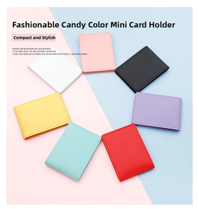 Flat lay of colorful slim card holders in seven candy colors on a two-tone background