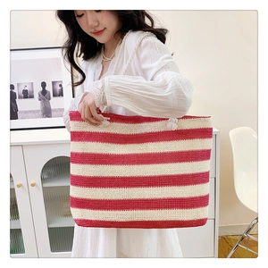 Fashionable large woven straw tote bag with red and white stripes and rope handles