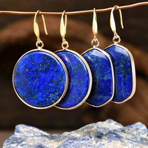 Lapis lazuli geometric drop earrings with gold hooks on a natural wood background
