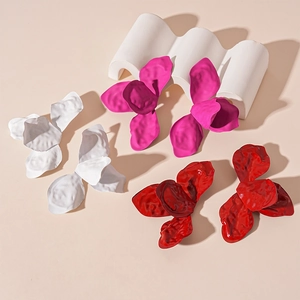 Three pairs of oversized wrinkled petal flower earrings in white, magenta, and burgundy red