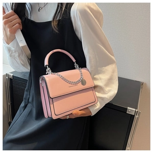 Close-up of pink PU leather crossbody bag with silver chain and Fashion & Bags text