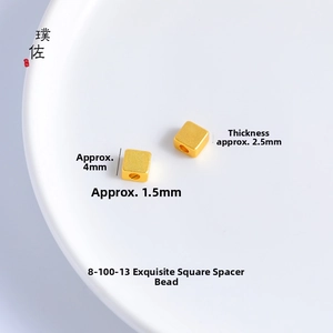 Macro shot of 4mm gold square spacer beads with 1.5mm holes for DIY jewelry making