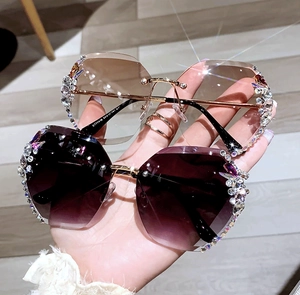 Detail view of rhinestone-embellished oversized rimless sunglasses with gradient lenses