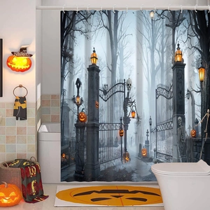 Detail of Halloween shower curtain featuring gothic cemetery gates and glowing pumpkins