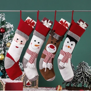 Detailed view of four knitted Christmas stockings with Santa, snowman, and reindeer patterns