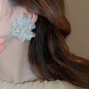 Detail of layered light blue organza flower earrings with delicate white bead stamens