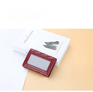 Macro shot of burgundy PU leather card holder with diamond quilted pattern and clear ID slot