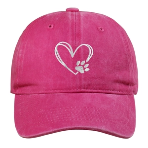 Detailed view of white double-heart and paw embroidery on rose red washed cotton cap