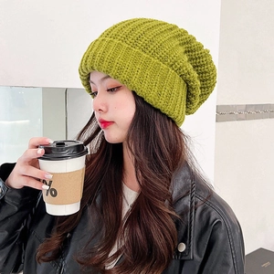 Oversized grass green knitted beanie for women with a warm winter thermal wool texture