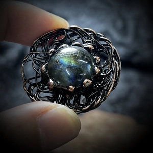 Detail of handmade wire wrapped labradorite ring with antique bronze nest setting