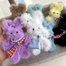 Detailed shot of plush rabbit charms with pearl necklaces and plaid bags in various colors