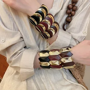Bohemian style moon-shaped stretch bracelet with gold metal and burgundy resin modules