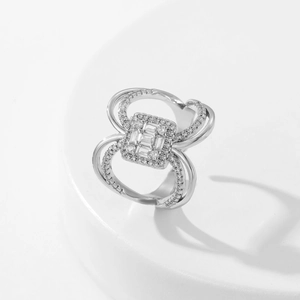 Detailed view of silver ring featuring square zircon inlay and intertwined paved bands