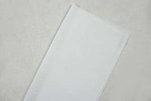 Detailed close-up of white mesh fabric texture and breathable honeycomb knit material