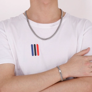 Polished silver cuban chain necklace and matching bracelet set worn by a male model