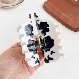 Chic acetate cow print hair claw clip for women featuring a stylish black and white pattern