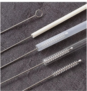 Detail showing various soft bristle straw brushes cleaning different sized pipe tubes