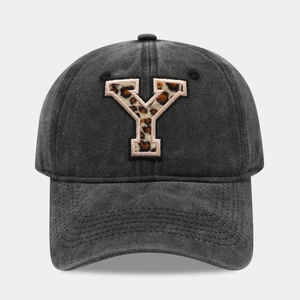 Close-up of leopard print letter Y embroidery on charcoal grey washed cotton baseball cap
