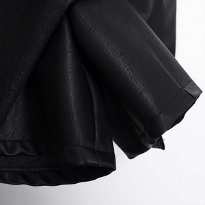 Close-up of black PU leather skirt featuring natural texture and fine stitching detail