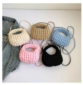 Collection of quilted puff shoulder bags in various colors on minimalist background