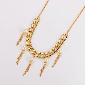 Elegant gold Cuban chain necklace with pearls and metallic tassels on white background