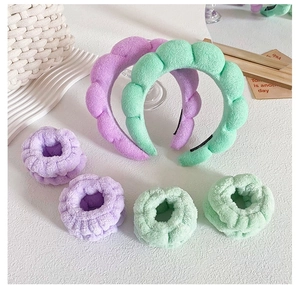 Detail of plush braided headbands and wristbands set in purple and mint green color