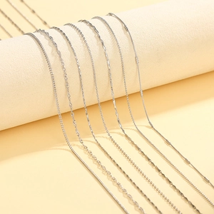 Detail showing assorted silver box, water wave, and snake chain necklaces for women