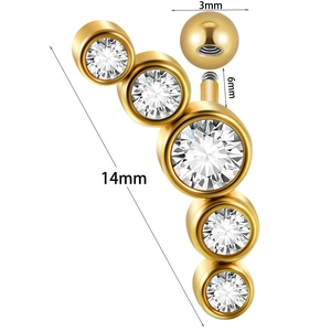 Macro detail of gold stainless steel labret stud with 14mm curved row of clear zircons