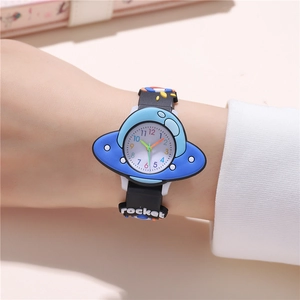 Close-up of a blue UFO watch face and soft black silicone rocket pattern strap