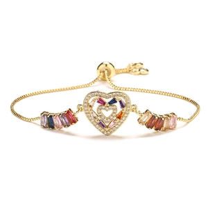 Adjustable gold heart bracelet with colorful baguette zircon stones on white background