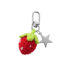 Handmade crochet strawberry keychain with red yarn body, green leaves, and star charm