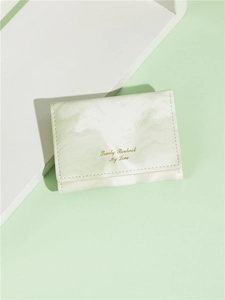 Close-up of light green marble patterned card holder with gold stamped lettering