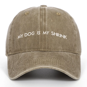 Close-up of MY DOG IS MY SHRINK white embroidery on washed cotton baseball cap