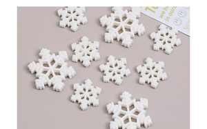 Macro view of white glitter snowflake resin charms for DIY creative craft projects