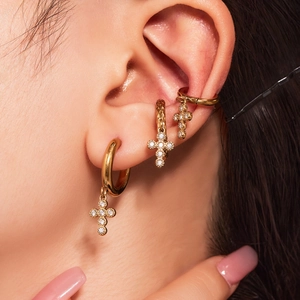 Classic gold-plated U-shaped hoop earrings with zircon cross pendant worn on ear