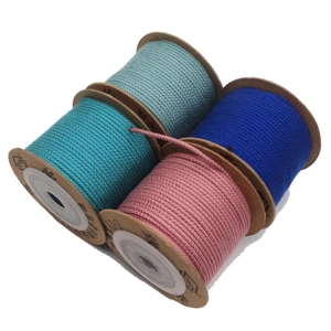 Close-up of four spools of 1.5mm cotton cord in light blue, dark blue, cyan, and pink