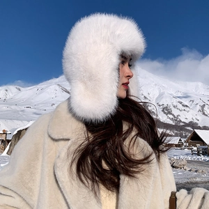 Detail of white plush trapper hat with thick faux fur material and earflaps for winter