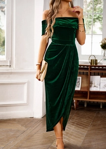 Detail showing the dark green velvet fabric texture and pleated off-the-shoulder design