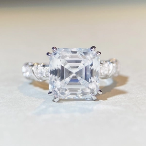 Macro view of Asscher cut moissanite ring with square stone and silver band detailing