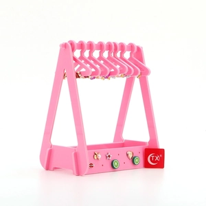 Pink acrylic clothes hanger earring organizer with fruit base tray on white background