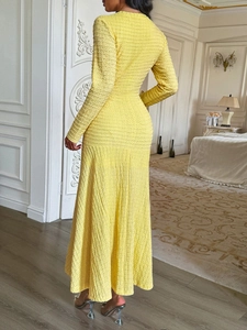 Detailed back view of a yellow short sleeve dress showing pleated texture and A-line silhouette
