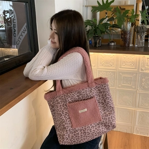Macro shot of pink leopard print tote with soft faux fur pocket and strap texture detail