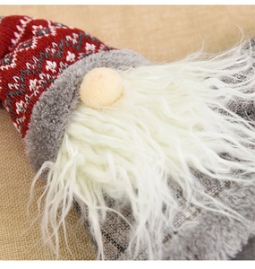 Detail showing the knitted fabric texture and plush beard of the Christmas gnome