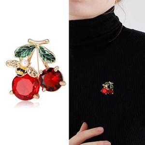 Cute cherry brooch with red crystals, green enamel leaves, pearl, and bee on gold base