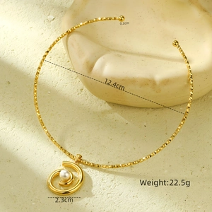 Detail view of a gold choker with spiral pearl pendant showing 12.4cm inner diameter size