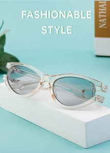 Close-up of trendy oval sunglasses featuring hollow-out frame design and gradient lenses
